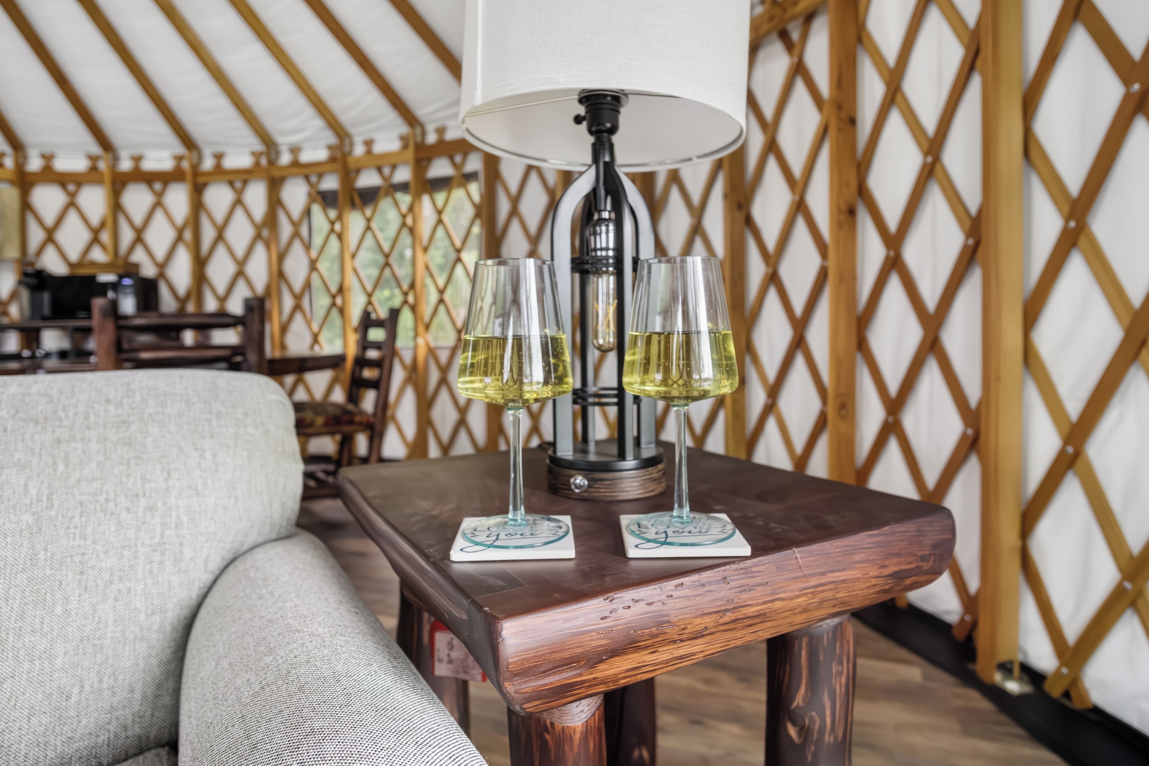 Cozy yurt interior with rustic charm, wine setup, and inviting lounge space