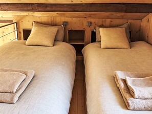 A room with two beds, each with a pillow and a folded towel. - The Stalluccia by Interhome (Stampa)