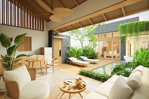 A modern interior with a dining area, lounge chairs, a pool, and lush greenery. - Athene Villa Seseh (Badung)
