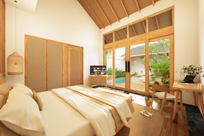 A bedroom with a bed, a television, and a view of a swimming pool. - Athene Villa Seseh (Badung)