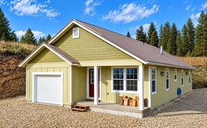 A single-story house with a garage, a front porch, and a red door. - Scenic Mountain Escape, Relax, Unwind & Explore (Boise)