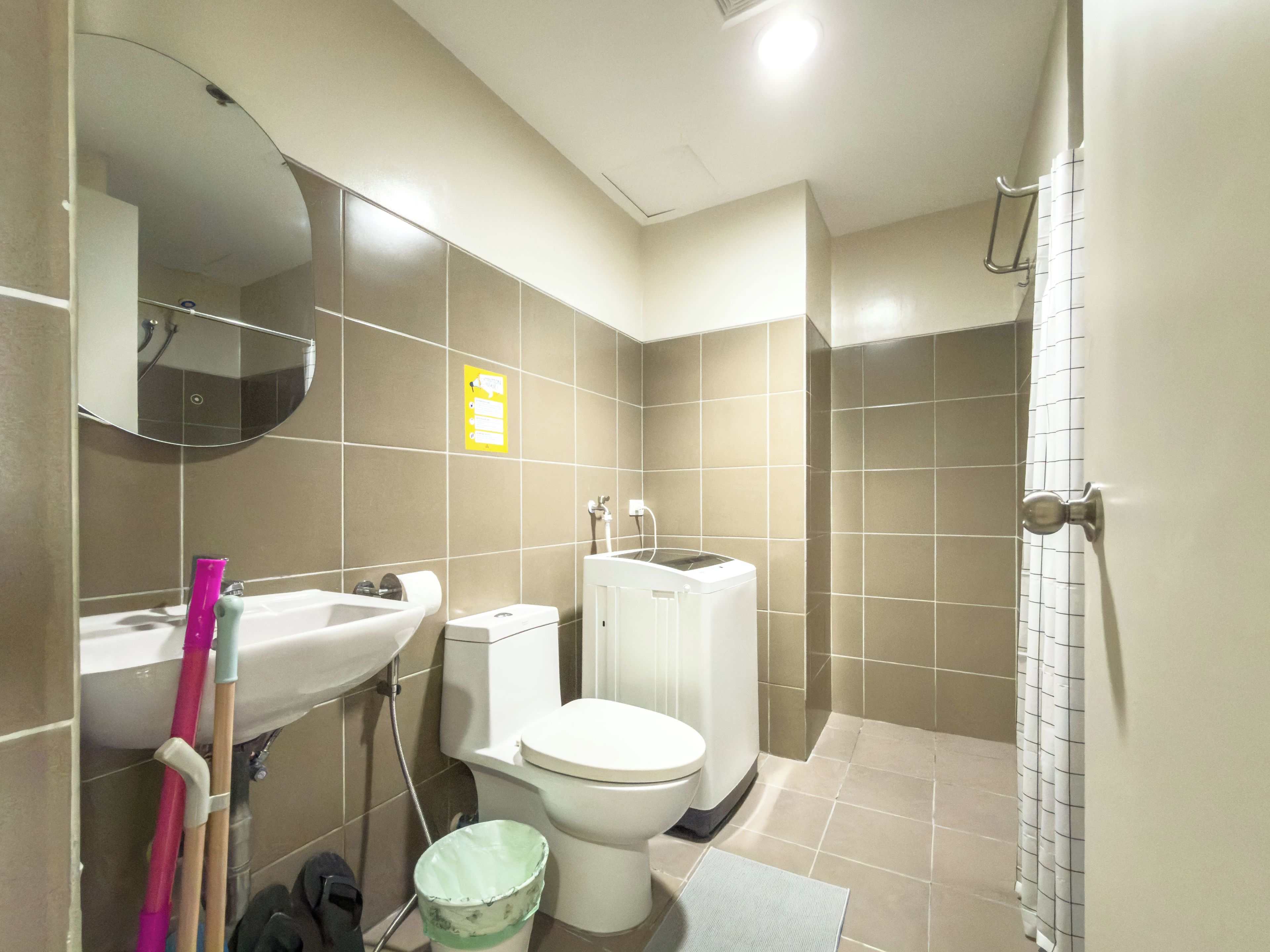 A bathroom with a toilet, sink, and shower.