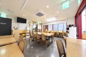 A conference room with tables and chairs, a whiteboard, a TV, and a staff-only door. - REDSTAY (Seoul)