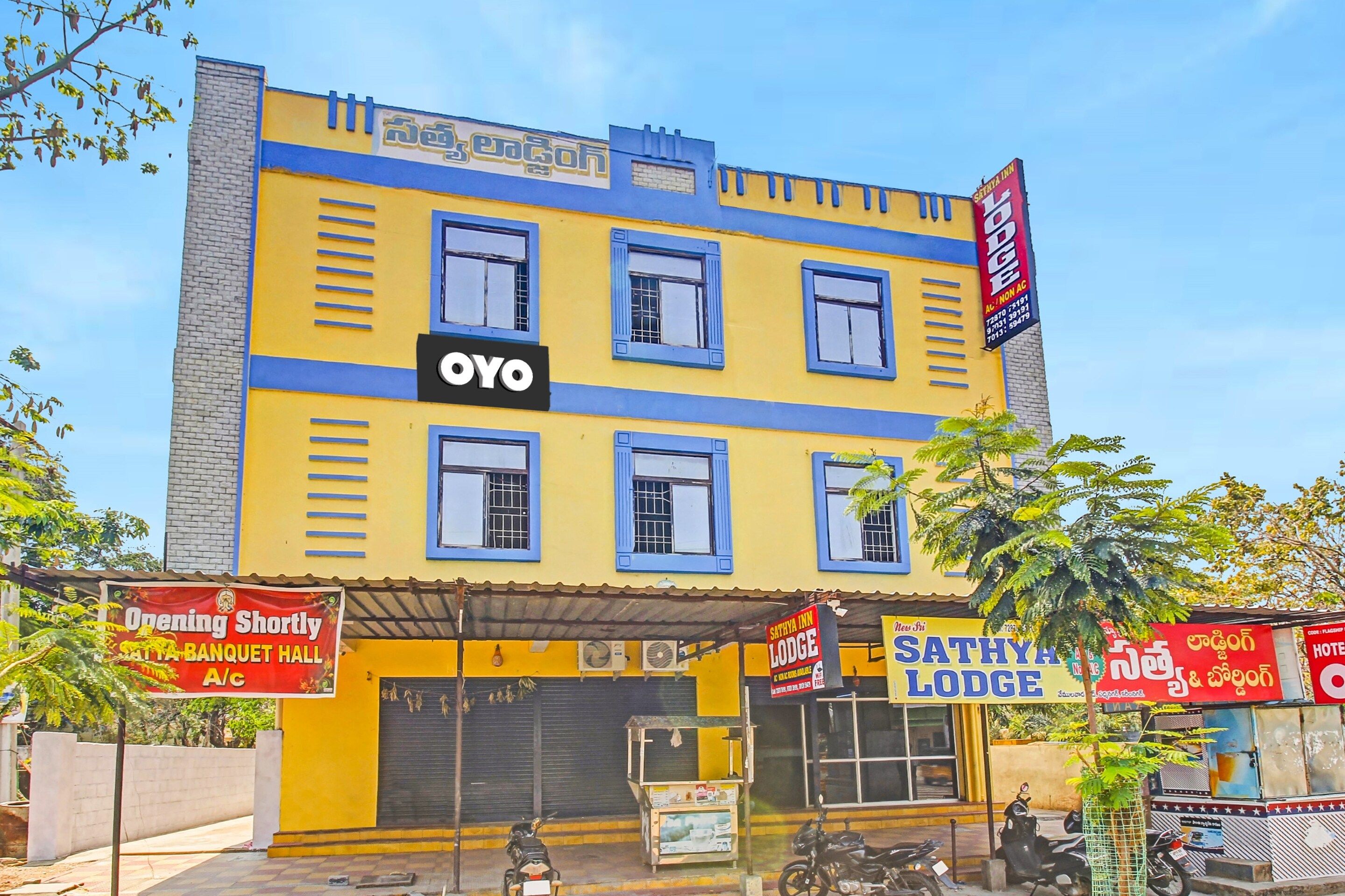 A multi-story building with a prominent 'OYO' sign, indicating a hotel or lodging establishment.