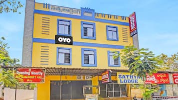 A multi-story building with a prominent 'OYO' sign, indicating a hotel or lodging establishment.