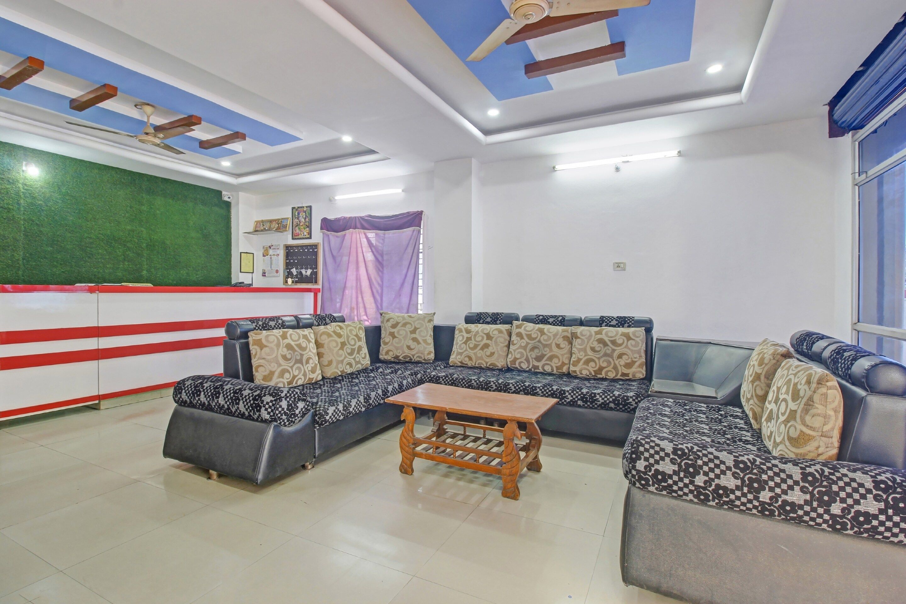 A modern living room with a sectional sofa, a wooden coffee table, and a ceiling fan.