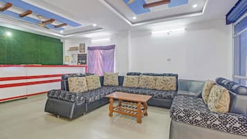 A modern living room with a sectional sofa, a wooden coffee table, and a ceiling fan.