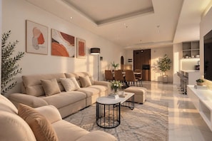 Una sala de estar moderna con sofá, mesa de centro y comedor.