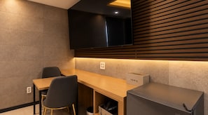 A modern kitchen with a wooden countertop, a built-in TV, and a hair dryer in a box. - Herium Hotel Gumi (Gumi)