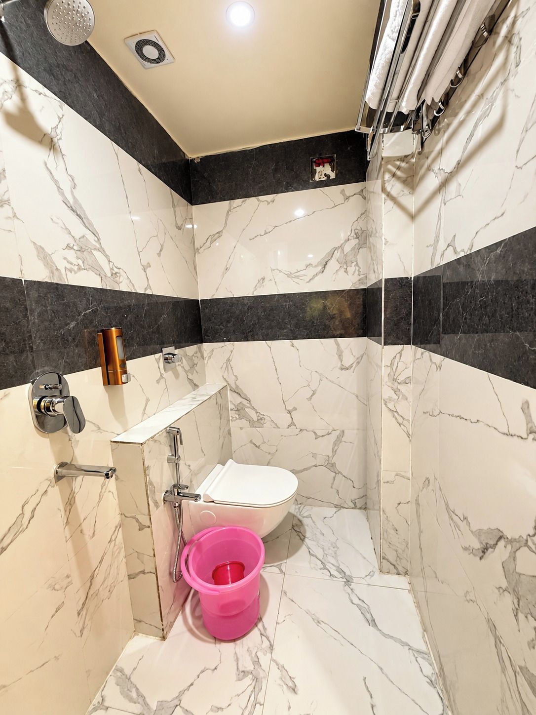 A bathroom with a toilet, sink, and shower.