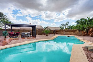 A swimming pool with a patio area, a pergola, and a brick wall. - Private Pool Oasis | Fiber Wi-Fi | Near Stadium (Peoria)
