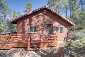 A wooden cabin with a porch, two windows, and a door. - Cozy Prescott Cabin, Surrounded By Ponderosa Pines (Prescott)