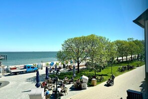 A seaside patio with outdoor seating, a view of the sea, and a parked bicycle. - House with sea view - Apt. 2 (Wyk auf Föhr)