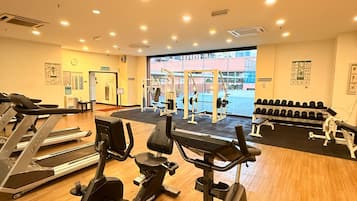 A gym with treadmills, stationary bikes, and weight machines.