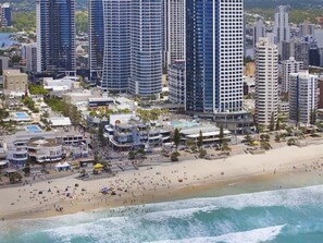 A coastal cityscape with high-rise buildings, a sandy beach, and a marina. - Ocean View Circle on Cavill 2BR Apartment (Gold Coast)