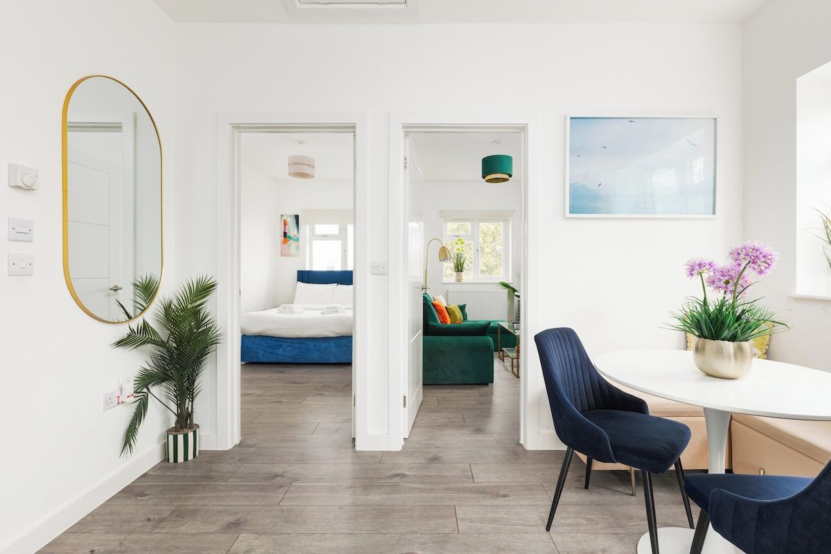 A modern interior with a dining area, a bed, and a living space.