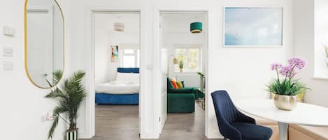 A modern interior with a dining area, a bed, and a living space.