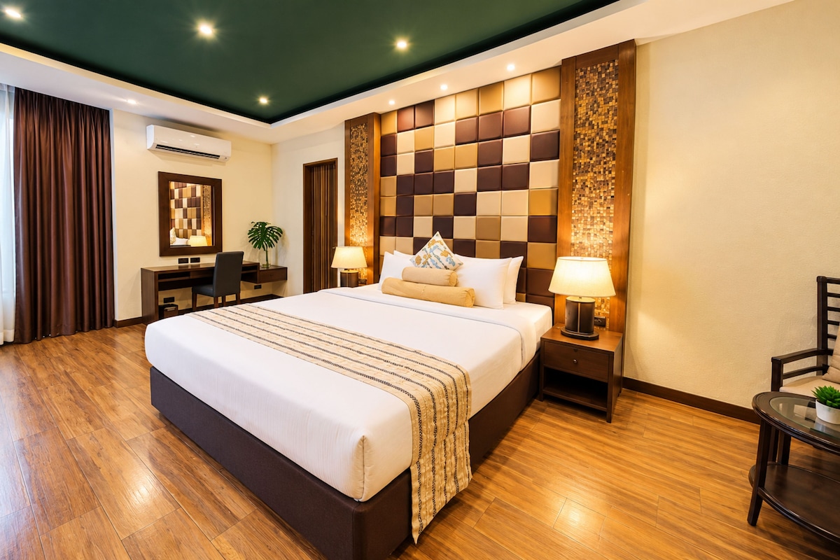 A hotel room with a large bed, bedside lamps, a desk, and a chair.