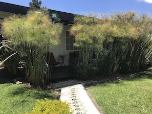 A pathway leading to a building entrance with a small porch area. - Hotel & Golf Isak (Rionegro)
