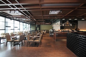 A spacious restaurant with high ceilings, exposed beams, and a long counter with a variety of dishes displayed. - Salaam Suites Shah Alam (Shah Alam)