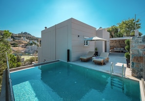A modern poolside area with a clear view of the surrounding landscape. - Villa Amoudi Private Pool (HERAKLION)
