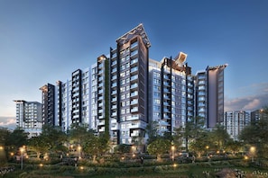 A high-rise residential building with multiple balconies, surrounded by landscaped gardens and street lamps. - DIAMOND ALNATA BY EMILY IN TOWN (Tân Sơn Nhì)