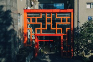 A building facade with a geometric pattern and a visible entrance. - Cloudscape Apartment (Chengdu)