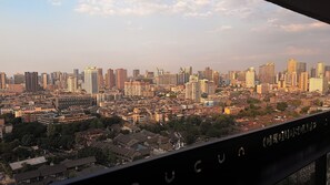 A cityscape with high-rise buildings and traditional architecture. - Cloudscape Apartment (Chengdu)