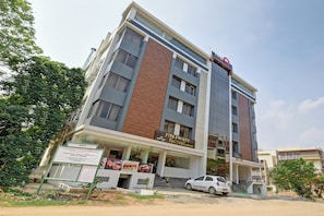 A multi-story building with a sign for 'Pita Pocket Factory' on the ground floor. - Super collection O I J SUITES (Bangalore)