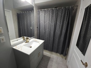 A bathroom with a white sink, a mirror, and a shower curtain with a chevron pattern. - Room-waterfront Autumn Getaway With Priv (Whitchurch-Stouffville)