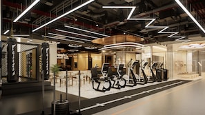 Ein modernes Fitnessstudio mit Trainingsgeräten und einer Sitzgelegenheit.
