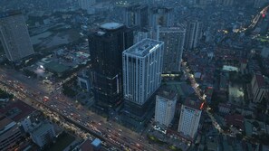 A high-rise building with a modern architectural design, surrounded by other buildings and busy streets. - Nancy Apartment Capital Elite - My Dinh (Tu Liem Ward)
