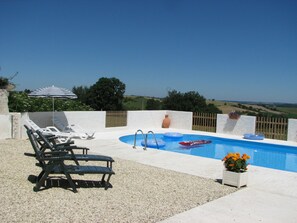 A pool area with lounge chairs, a small pool, and a view of the countryside. - Holiday Home 'Limerac Farmhouse' with Shared Pool, Shared Terrace and Wi-Fi (Salles-Lavalette)