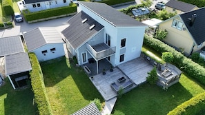 A two-story house with a balcony, a deck, and a fenced yard. - Charming Bro Retreat, Luxury Comfort & Modern Amenities (Bro)