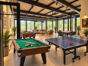 A recreational area with pool tables, a foosball table, and a ping pong table. - Corbett KāSā (Ramnagar)