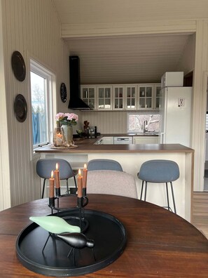 A dining area with a wooden table, chairs, and a candle holder.