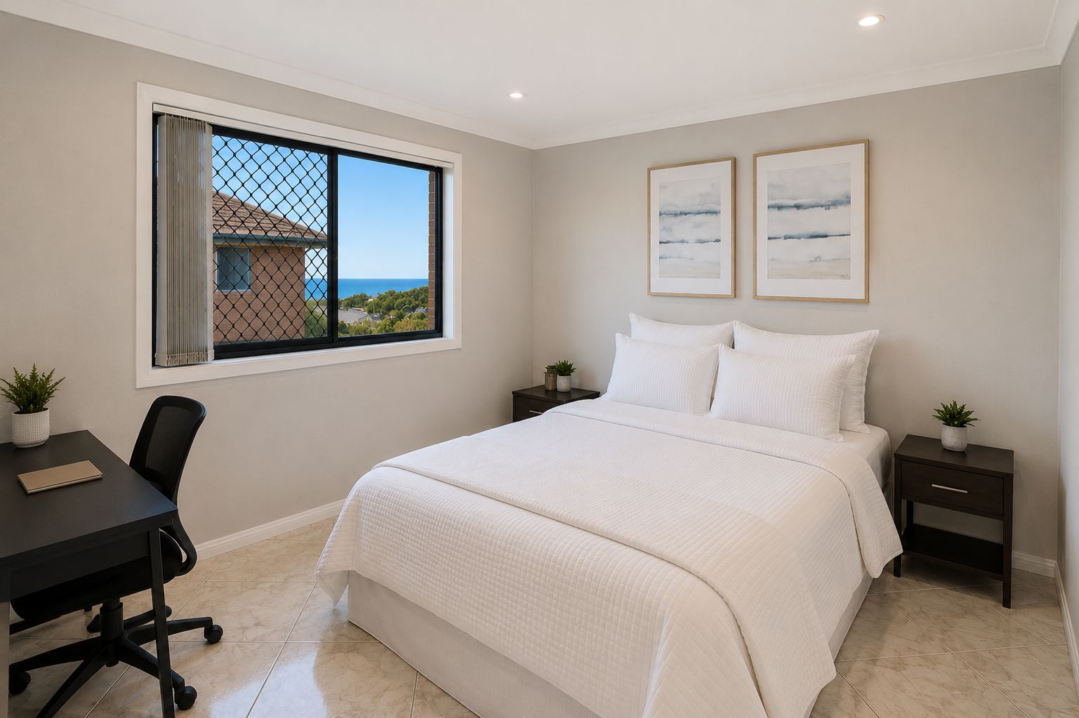 A bedroom with a bed, a desk, and a window with a view.