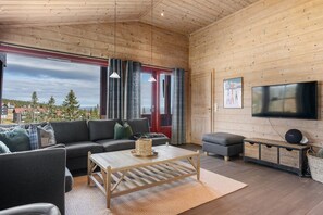 A cozy living room with a sofa, a coffee table, and a television. - FA301 Top-Floor flat with Sauna, Three Balconies (Trysil)
