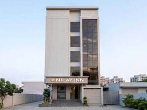 A modern building with a sign reading 'NILAY INN' at the entrance. - Classic Nilay Inn (Pandharpur)