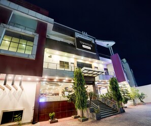A multi-story building with a sign reading 'TOWNHOUSE Company-Serviced'. - Classic Hotel Nirmal Residency (Bhopal)