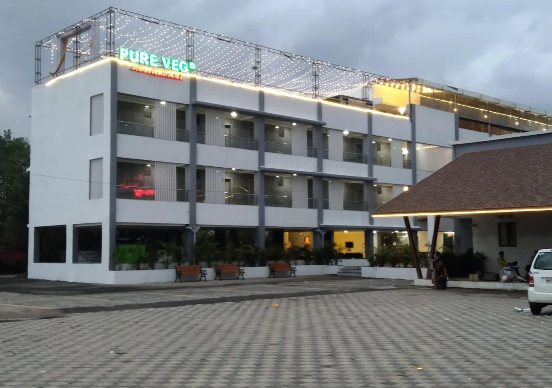 A multi-story building with a sign reading 'PURE VEG Restaurant.'