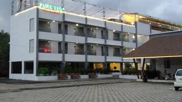 A multi-story building with a sign reading 'PURE VEG Restaurant.'