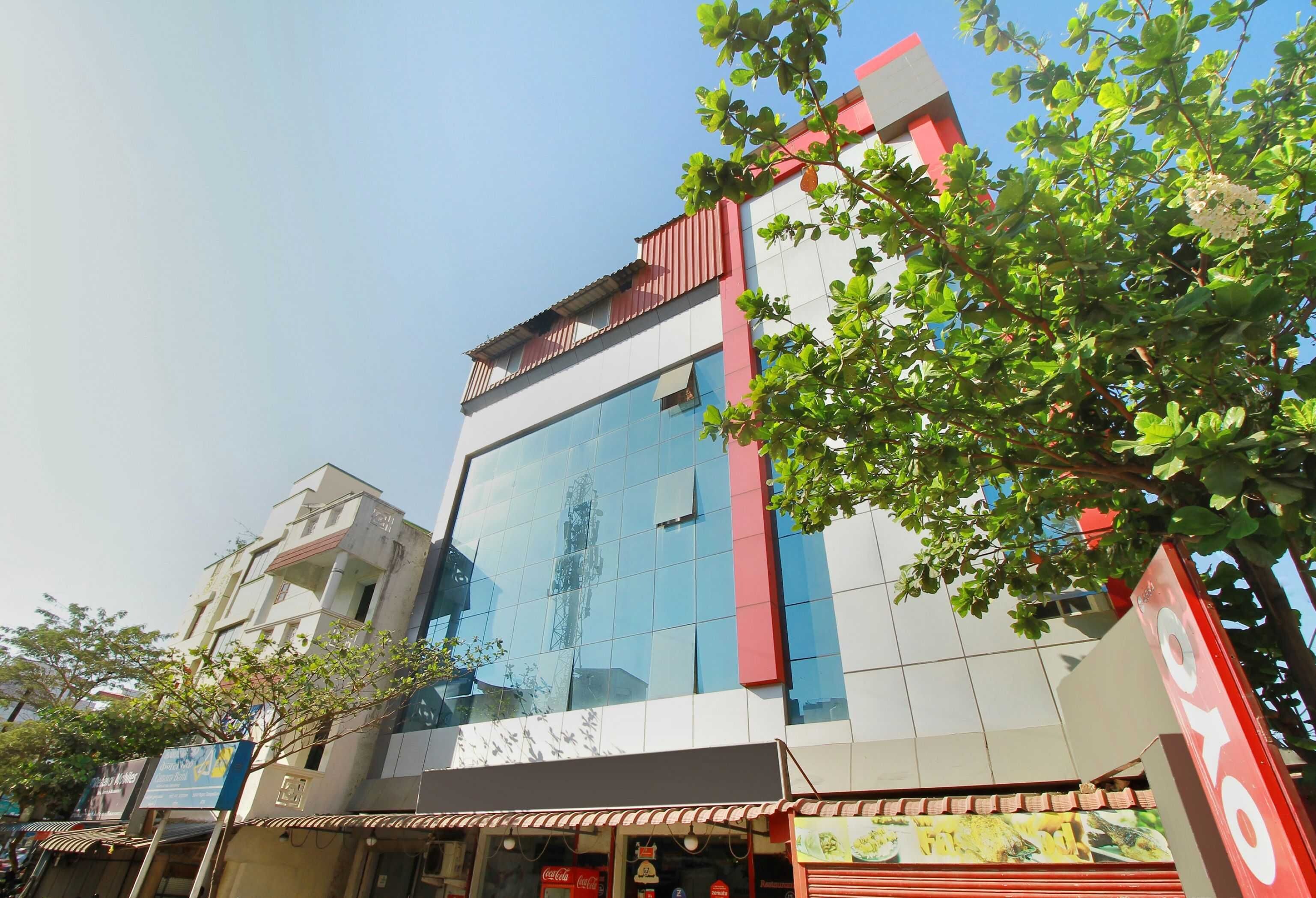 A multi-story building with a glass facade, a red and white color scheme, and a visible Coca-Cola sign.