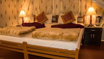 A bed with a wooden frame, two bedside tables with lamps, and patterned curtains.