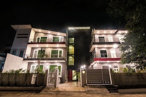 A multi-story building with a prominent entrance and a sign that reads 'CITYHOUSE'.