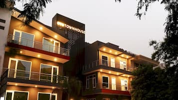 A multi-story building with a sign reading 'OYO TOWNHOUSE.'
