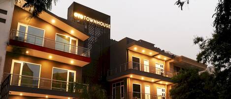 A multi-story building with a sign reading 'OYO TOWNHOUSE.'