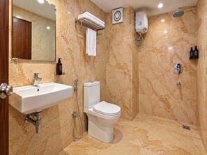 A bathroom with a sink, toilet, and shower. - Classic Hotel Leela Imperial (Visakhapatnam)