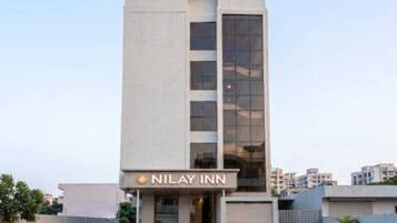 A modern building with a sign reading 'NILAY INN' at the entrance.