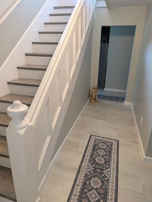 A staircase with white railings and wooden steps leading to a doorway. - Quiet 3BR Retreat Near Mohegan Sun & Foxwoods (Norwich)